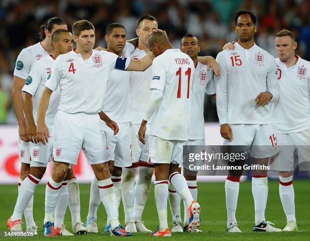 Steven Gerrard of England consoles Ashley Young after missing his penalty during the UEFA EURO 2012 quarter final match between England and Italy at...