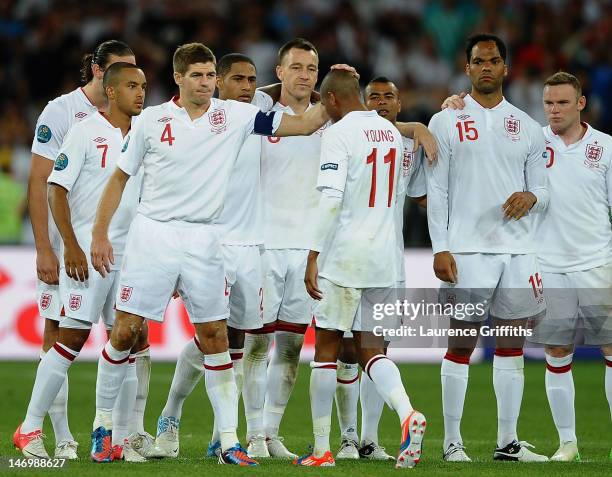 Steven Gerrard of England consoles Ashley Young after missing his penalty during the UEFA EURO 2012 quarter final match between England and Italy at...