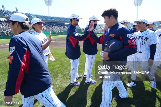 Yu Darvish and Munetaka Murakami of Samurai Japan high-five after a training session at Hinata Sun Marine Stadium on February 27, 2023 in Miyazaki,...