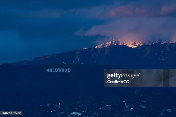 View of the downtown Los Angeles skyline with the snow-covered San Gabriel Mountains in the background seen from Kenneth Hahn Park as a winter storm...