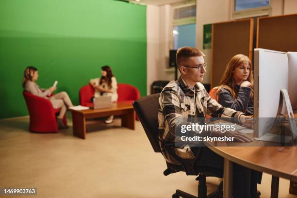 young editors working on desktop computers in a studio. - editing equipment stock pictures, royalty-free photos & images
