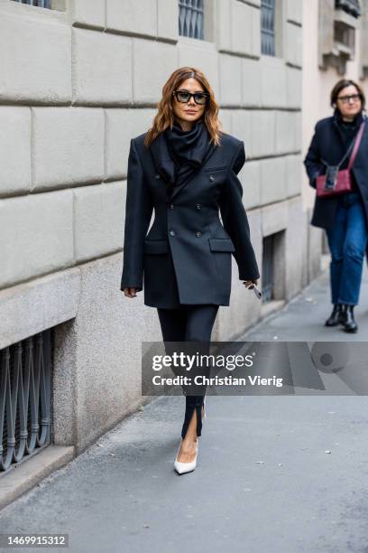 Christine Centenera wears black tailored blazer outside Giorgio Armani during the Milan Fashion Week Womenswear Fall/Winter 2023/2024 on February 26,...