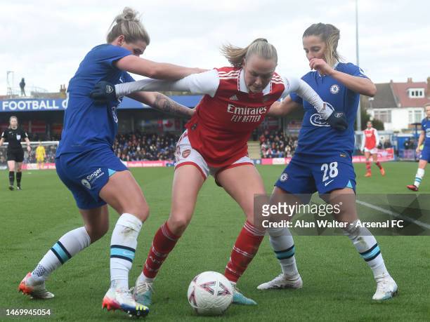 Frida Maanum of Arsenal is challenged by Mille Bright and Jelena Cankovic of Chelsea during the WSL match between Chelsea Women and Arsenal Women at...