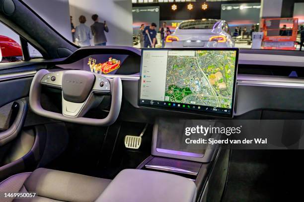 Tesla Model S full electric sedan interior with the yoke steering wheel and large touch screen on the dashboard at Brussels Expo on January 13, 2023...