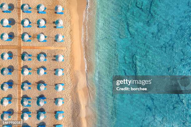 vue aérienne sur une plage de sable - parasol de plage photos et images de collection
