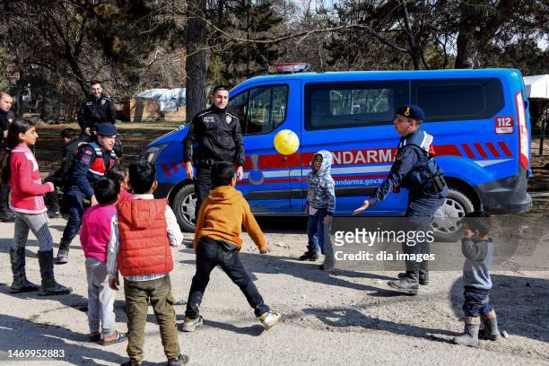 Kids are playing games with Turkish Gendarme in a tent city on February 27, 2023 in Malatya, Türkiye. The death toll from a catastrophic earthquake...