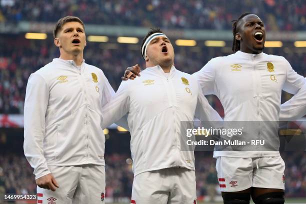 Owen Farrell, Jamie George and Maro Itoje of England sing the national anthem prior to the Six Nations Rugby match between Wales and England at...