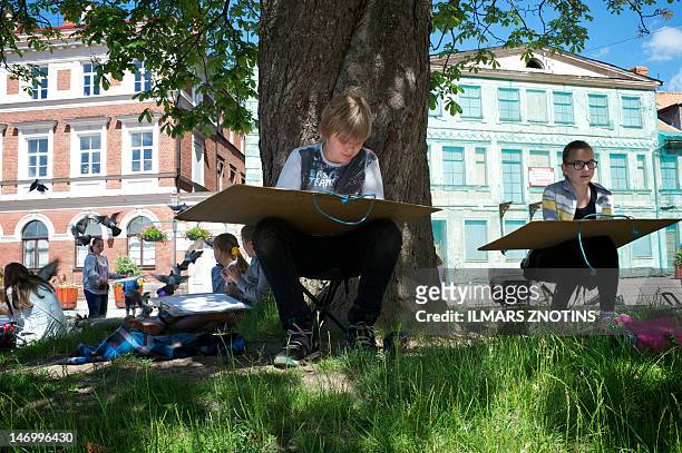 Children draw at the Rose square in the town in Cesis, 100 km from Riga , on June 14, 2012. Agris Lapins, head of the town's EU co-funded business...