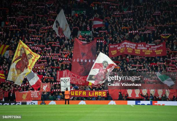 Liverpool fans on the Kop wave flags, scarves and banners before the UEFA Champions League round of 16 leg one match between Liverpool FC and Real...