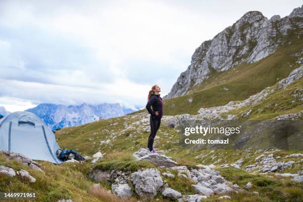 woman camping in the mountains - black jacket stock pictures, royalty-free photos & images