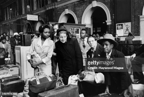 West Indian arrivals at Victoria Station after their journey from Southampton Docks being helped by Salvation Army members, June 1956. Original...