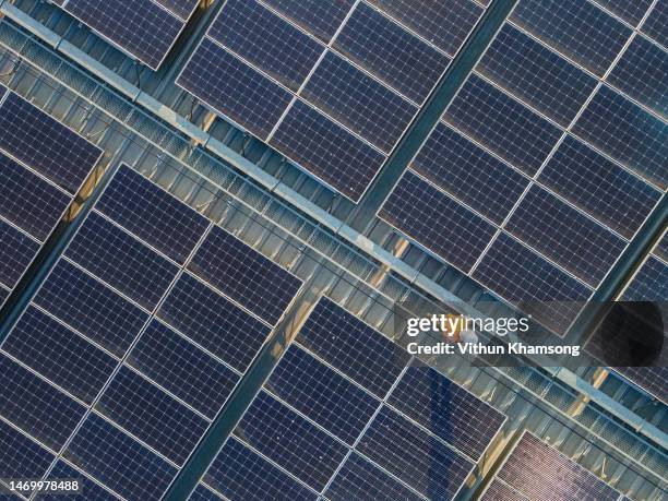 aerial view of engineers working at solar panels roof - aerial view construction workers stock-fotos und bilder