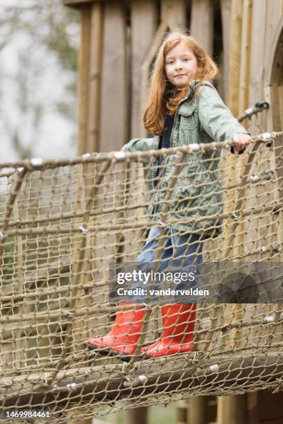 eight-year-old on play equipment - hanging bridge stock pictures, royalty-free photos & images