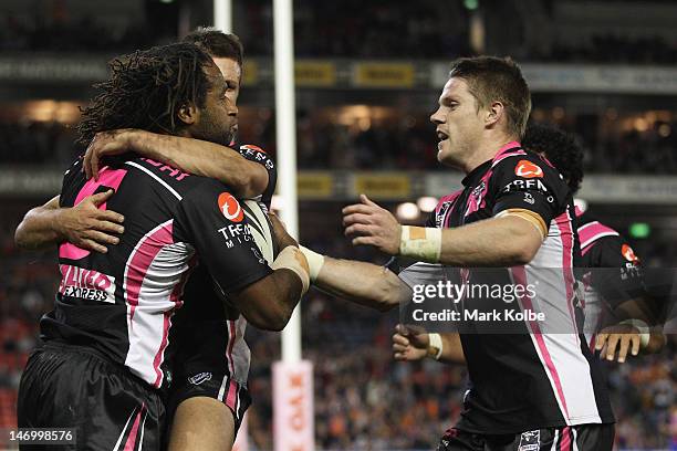 Lote Tuqiri and Chris Lawrence of the Tigers celebrate after Tuqiri scored a try during the round 16 NRL match between the Newcastle Knights and the...