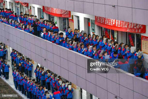 Senior three students study in the corridor outside a classroom to prepare for gaokao, China's national college entrance examination, on February 27,...