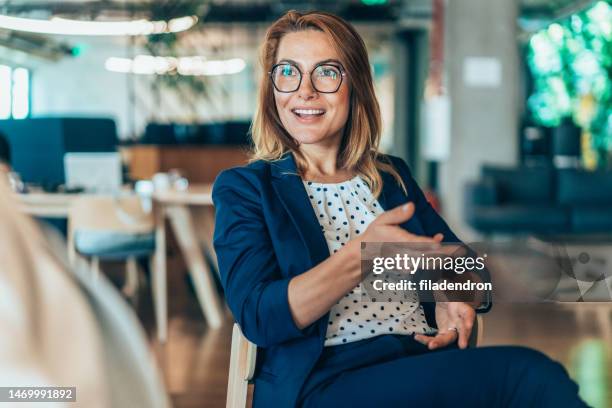 business woman talking to a colleague - sales meeting stock pictures, royalty-free photos & images