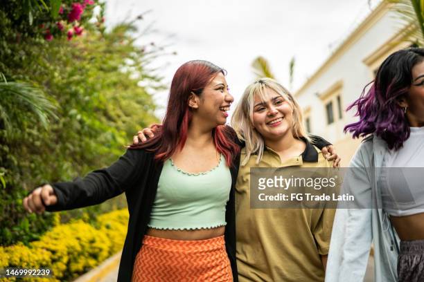 female friends having fun while walking on the street - group of friends stock pictures, royalty-free photos & images
