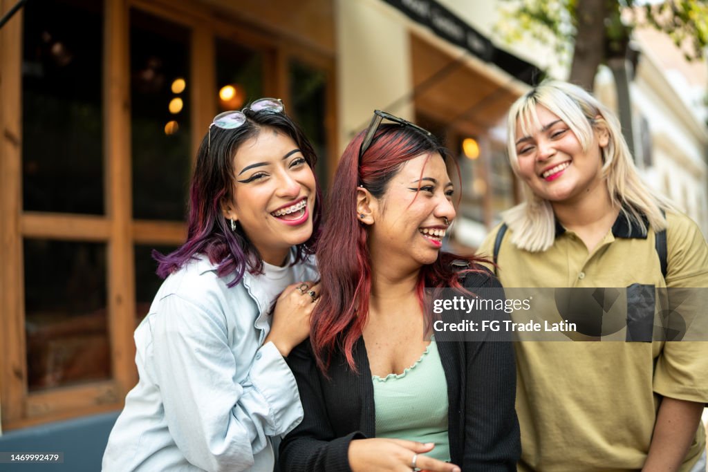 Happy female friends talking outdoors