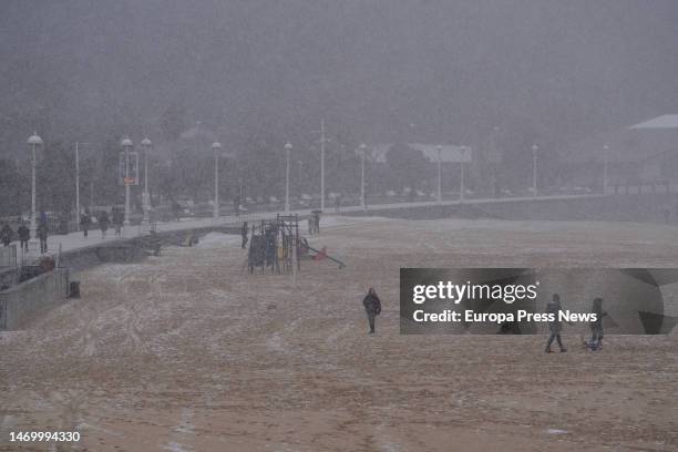 Several people on the snowy Ondarreta beach on February 27 in San Sebastian, Gipuzkoa, Basque Country, Spain. Euskadi is under yellow warning for...