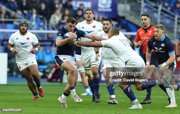 Ben White of Scotland is held by Gael Fickou during the Six Nations Rugby match between France and Scotland at the Stade de France on February 26,...