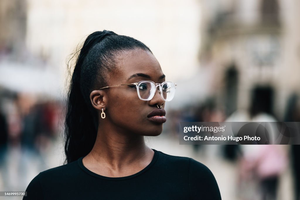 Portrait Of A Black Girl With Glasses In A Town Square High-Res Stock ...