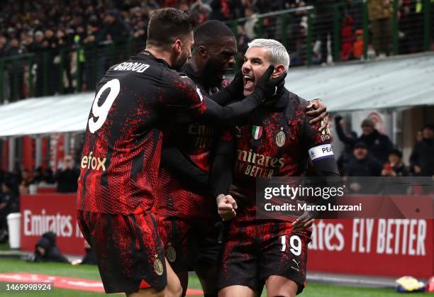 Theo Hernandez of AC Milan celebrates with teammates Olivier Giroud and after their shot is deflected into the goal by Juan Musso of Atalanta BC...