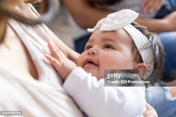 beautiful baby girl looks up at her mother - 4 months stock pictures, royalty-free photos & images