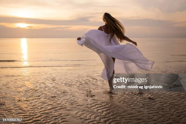 beautiful sunset on the beach - beach dress stock pictures, royalty-free photos & images