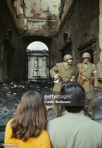 Heavily-armed riot police talk to a couple in front of the bombed-out ruins of the La Moneda presidential palace in Santiago, Chile, on October 4th,...