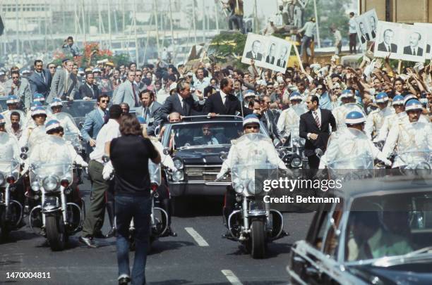 President Richard Nixon and Egyptian President Anwar Sadat are cheered by the crowds as their motorcade rides through Cairo and toward Koubbeh Palace...