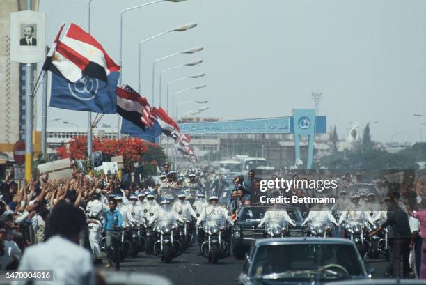 President Richard Nixon and Egyptian President Anwar Sadat are cheered by the crowds as their motorcade rides through Cairo and toward Koubbeh Palace...