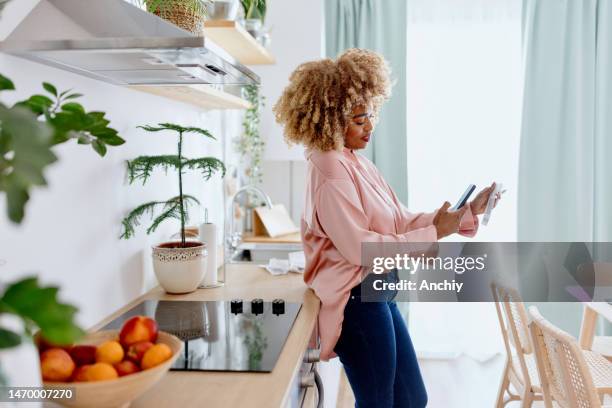 beautiful woman scanning a barcode with a smartphone - scan receipt stock pictures, royalty-free photos & images