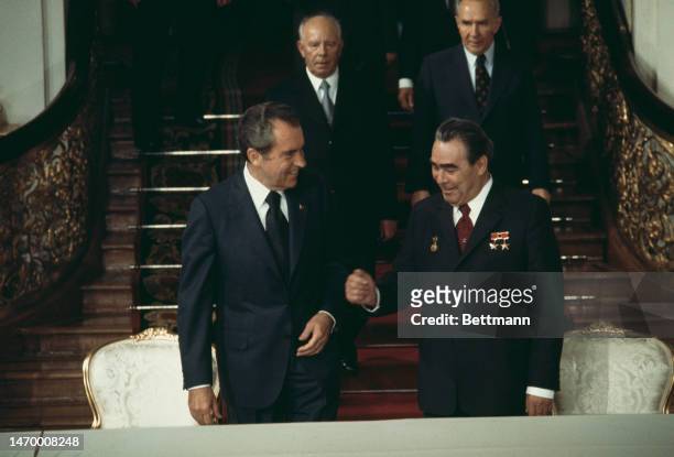President Richard Nixon and Soviet leader Leonid Brezhnev share a joke during a summit at the Kremlin in Moscow on June 28th, 1974. Behind them are...