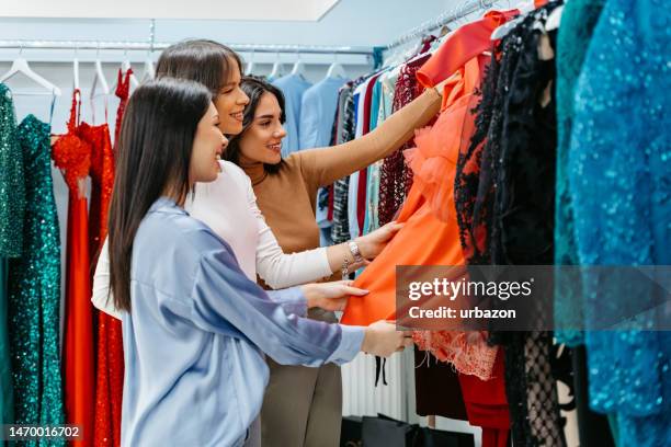 three female friends shopping together for prom dresses - prom stock pictures, royalty-free photos & images