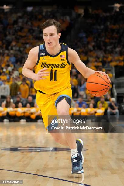 Tyler Kolek of the Marquette Golden Eagles dribbles the ball against the DePaul Blue Demons in the first half at Fiserv Forum on February 25, 2023 in...