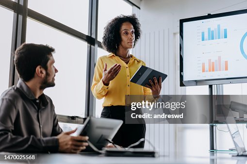 Business woman presenting financial result holding digital tablet Business woman presenting financial result holding digital tablet
