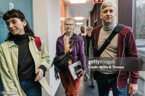 mature students on their way  to class together - bolso cruzado fotografías e imágenes de stock