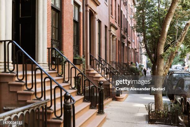 residential brownstone houses in west village, new york, usa - soho new york stock-fotos und bilder