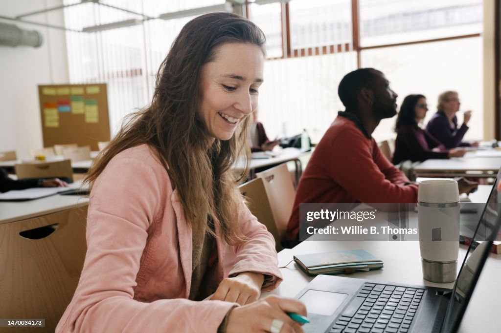 Mature Students Working In Classroom