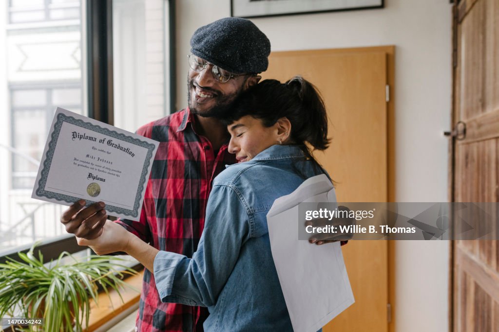 Mature Student Hugging Wife After Receiving Diploma