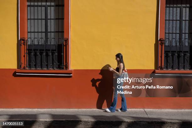 young tourist walking through the colourful streets of mexico's pueblos mágicos (magical villages) - mexico city tourist stock pictures, royalty-free photos & images