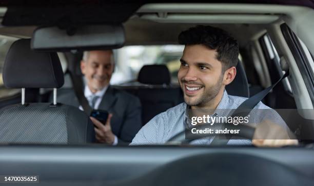 driver transporting a business man on a crowdsourced taxi - taxichauffeur stockfoto's en -beelden