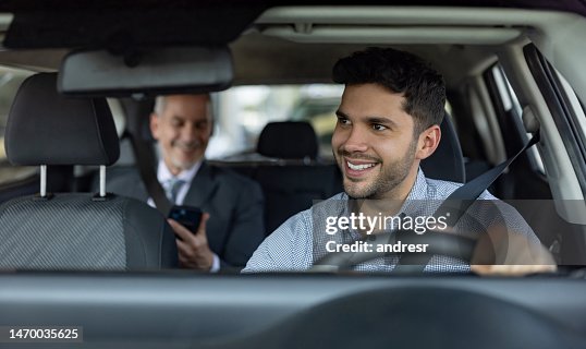 Driver transporting a business man on a crowdsourced taxi Driver transporting a business man on a crowdsourced taxi