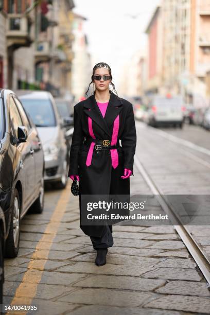 Guest wears silver hair clips, black sunglasses, a neon pink t-shirt, a neon pink silk tie, a black long oversized coat, black shiny leather with...