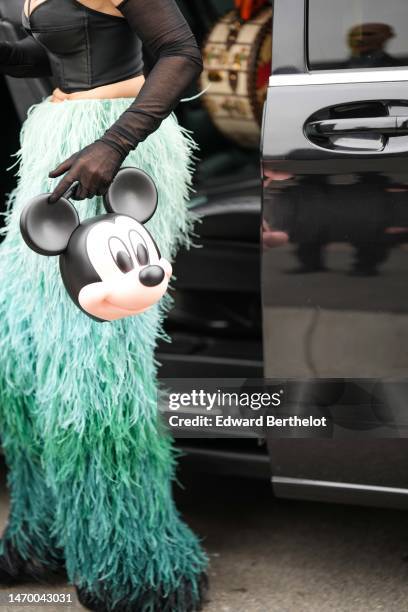 Guest wears a black V-neck / corset top, black tulle high gloves, pale green toe dark gradient print pattern fluffy large pants, a beige and black...