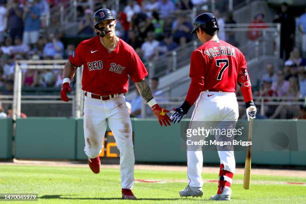 Jarren Duran of the Boston Red Sox celebrates a home run with teammate Masataka Yoshida of the Boston Red Sox during the fifth inning against the...