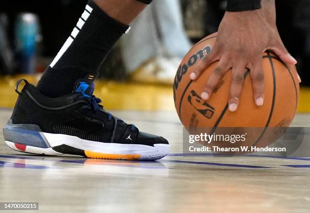 Detailed view of the Nike Air Jordan basketball shoes worn by Mike Conley of the Minnesota Timberwolves while picking up an official NBA basketball...