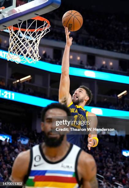 Klay Thompson of the Golden State Warriors goes in for a layup over Mike Conley of the Minnesota Timberwolves during the third quarter at Chase...