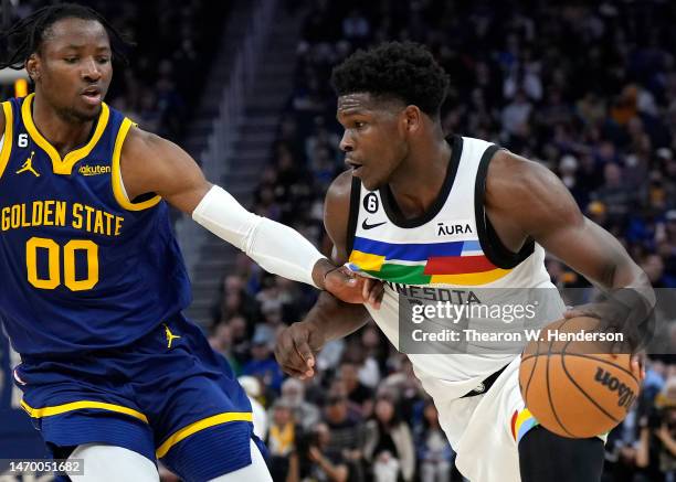Anthony Edwards of the Minnesota Timberwolves dribbling the ball while defended by Jonathan Kuminga of the Golden State Warriors during the second...