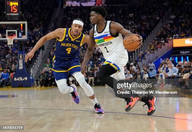 Anthony Edwards of the Minnesota Timberwolves dribbling the ball while defended by Moses Moody of the Golden State Warriors during the first quarter...